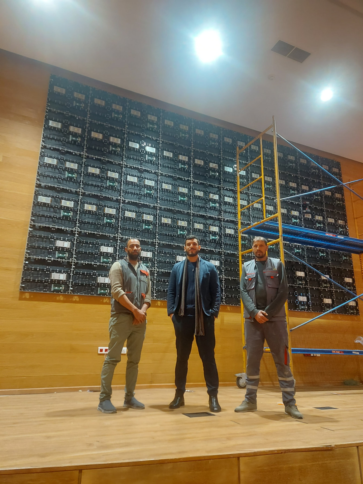 Équipe STARLED devant le mur LED pendant le montage dans l'auditorium